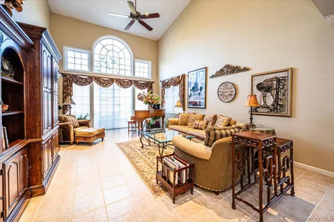 a view of a dining room with furniture and a chandelier
