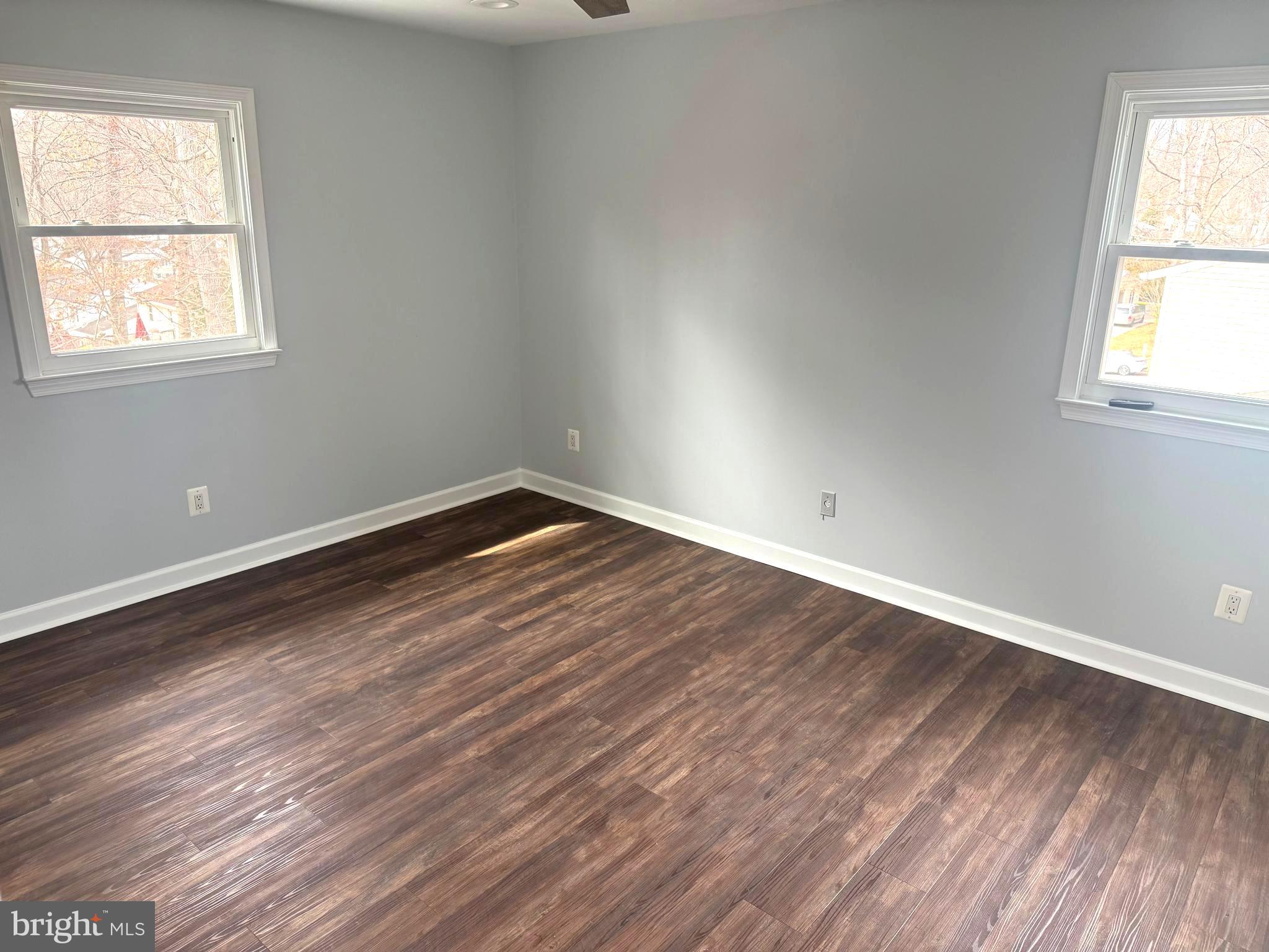 6602 Greenview Lane Springfield, VA 22152 - Photo 11 of 31 an empty room with wooden floor and windows