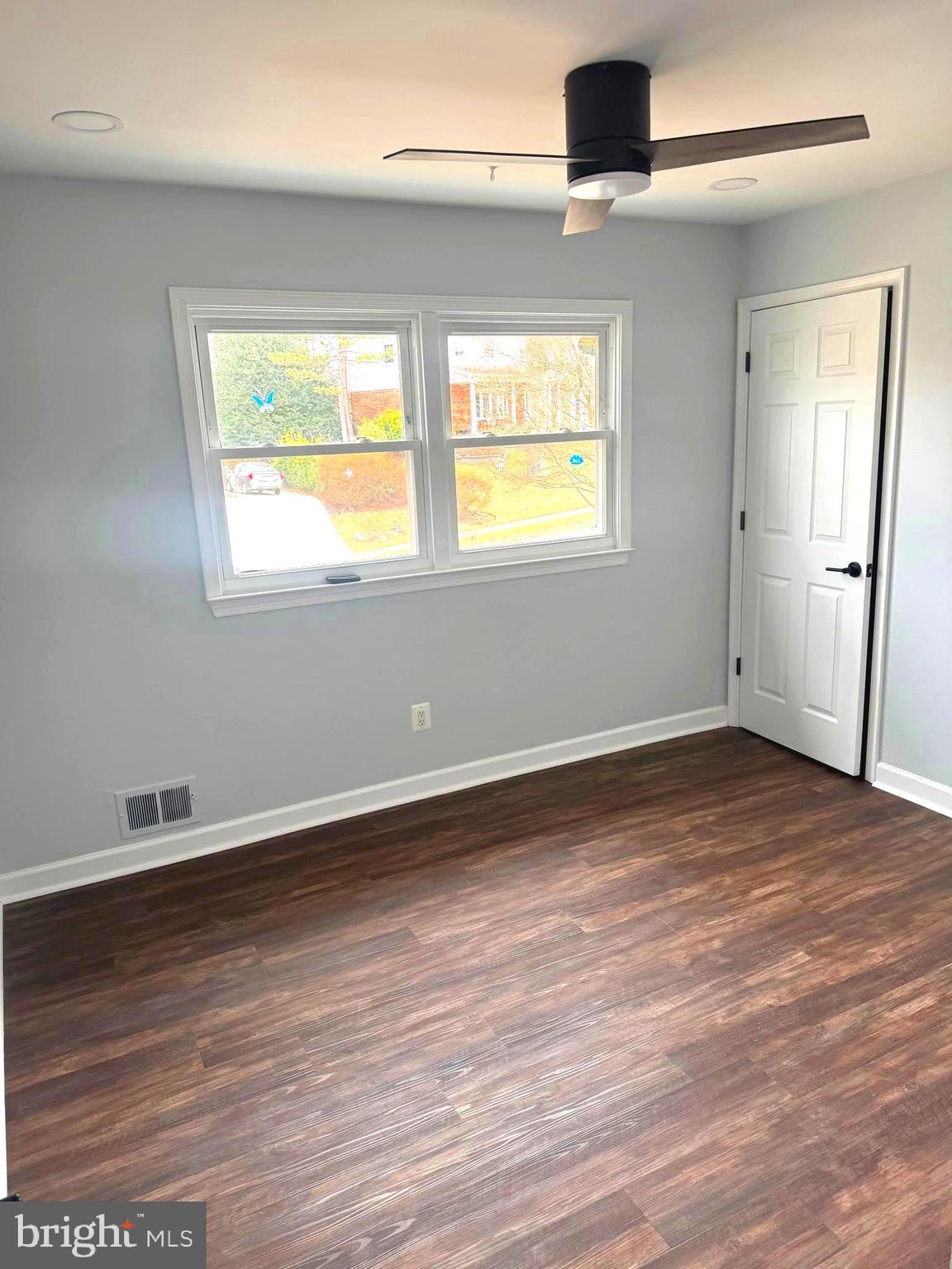 6602 Greenview Lane Springfield, VA 22152 - Photo 15 of 31 an empty room with wooden floor and windows