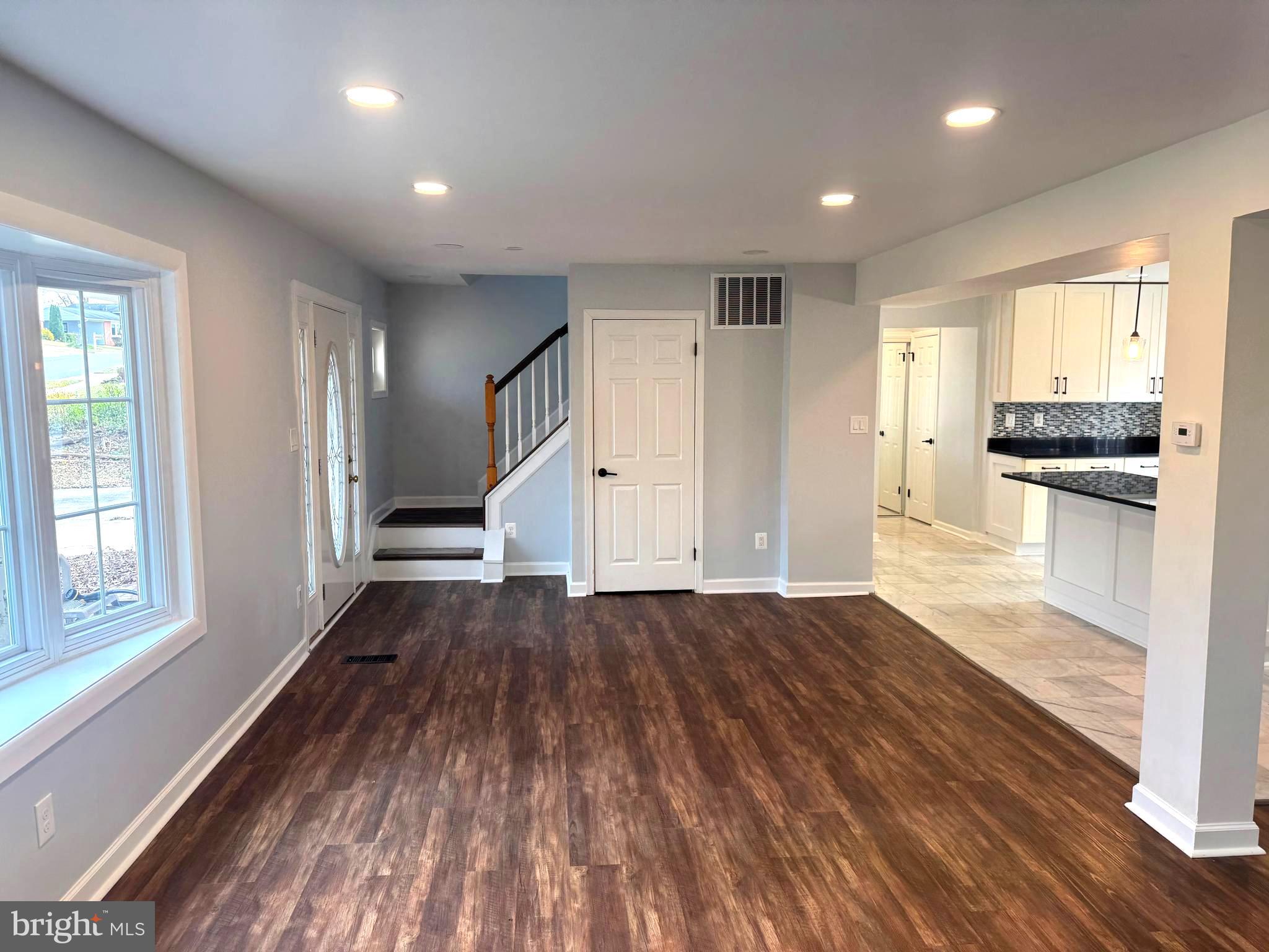 6602 Greenview Lane Springfield, VA 22152 - Photo 2 of 31 wooden floor in an empty room with a kitchen