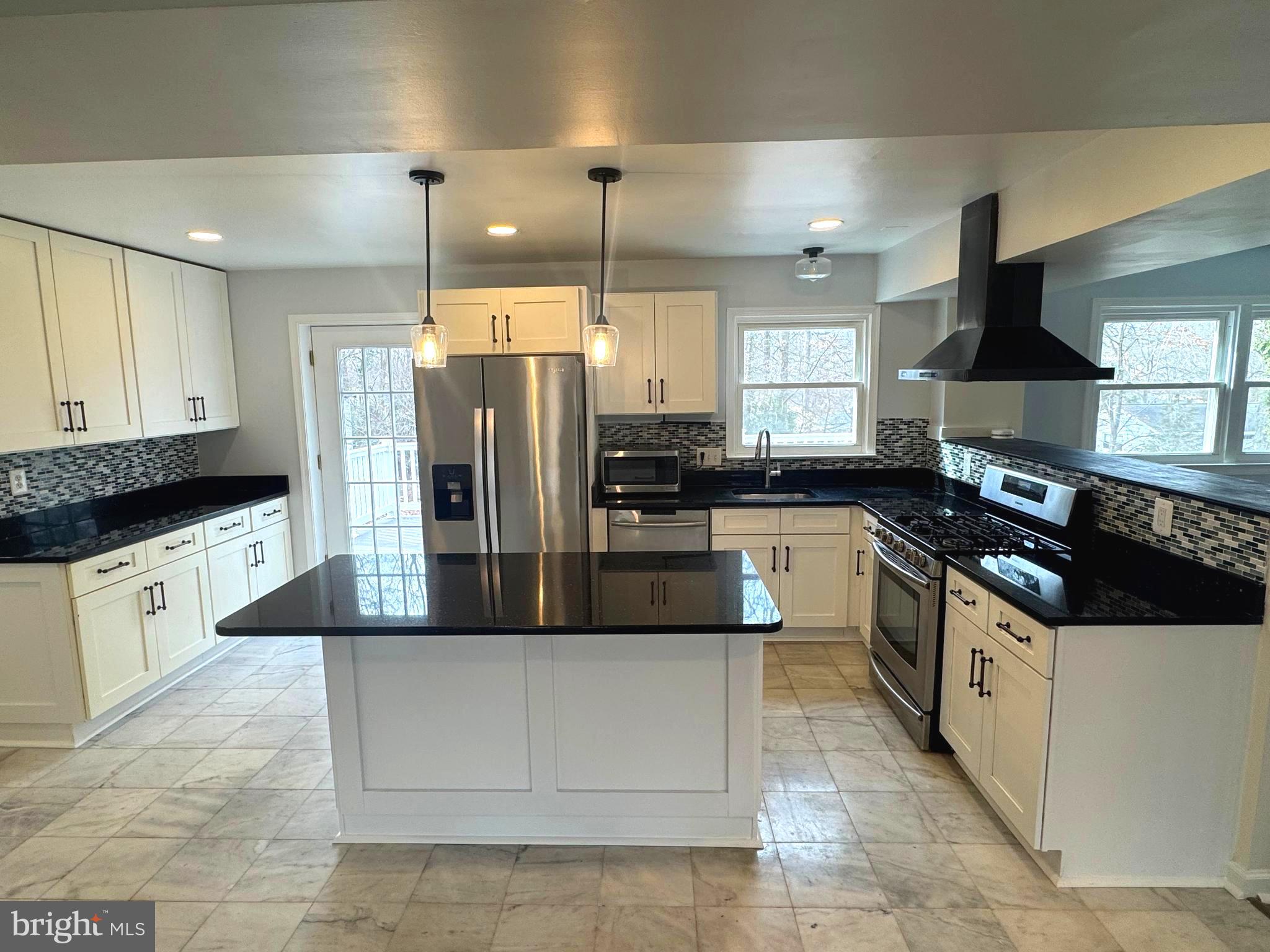 6602 Greenview Lane Springfield, VA 22152 - Photo 5 of 31 a kitchen with stainless steel appliances granite countertop a stove a sink and a refrigerator