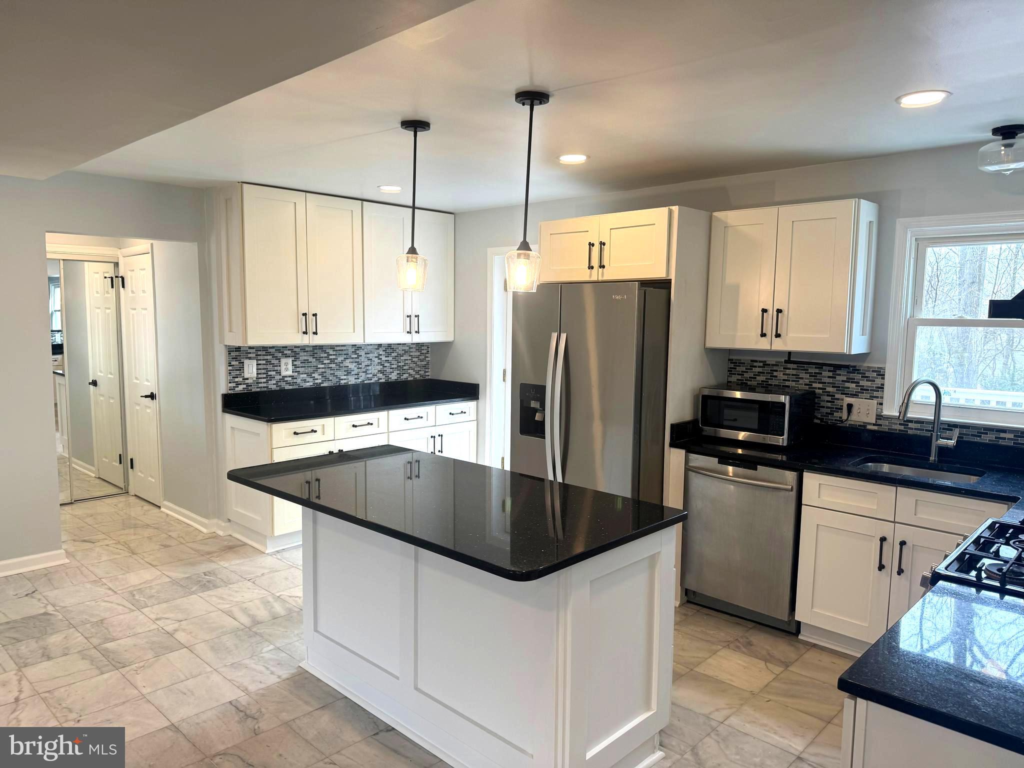 6602 Greenview Lane Springfield, VA 22152 - Photo 6 of 31 a kitchen with stainless steel appliances granite countertop a sink a stove a refrigerator and island