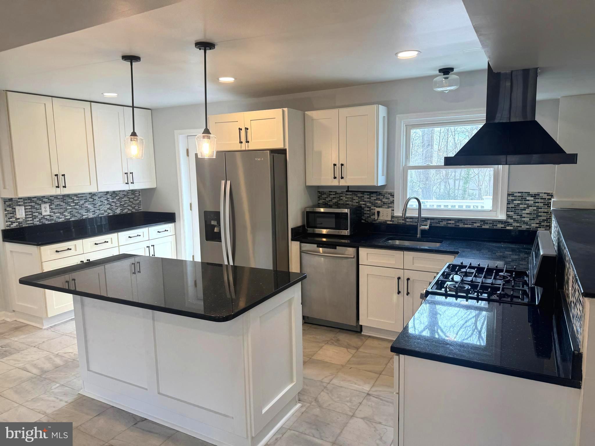 6602 Greenview Lane Springfield, VA 22152 - Photo 7 of 31 a kitchen with stainless steel appliances granite countertop a sink a refrigerator and a stove