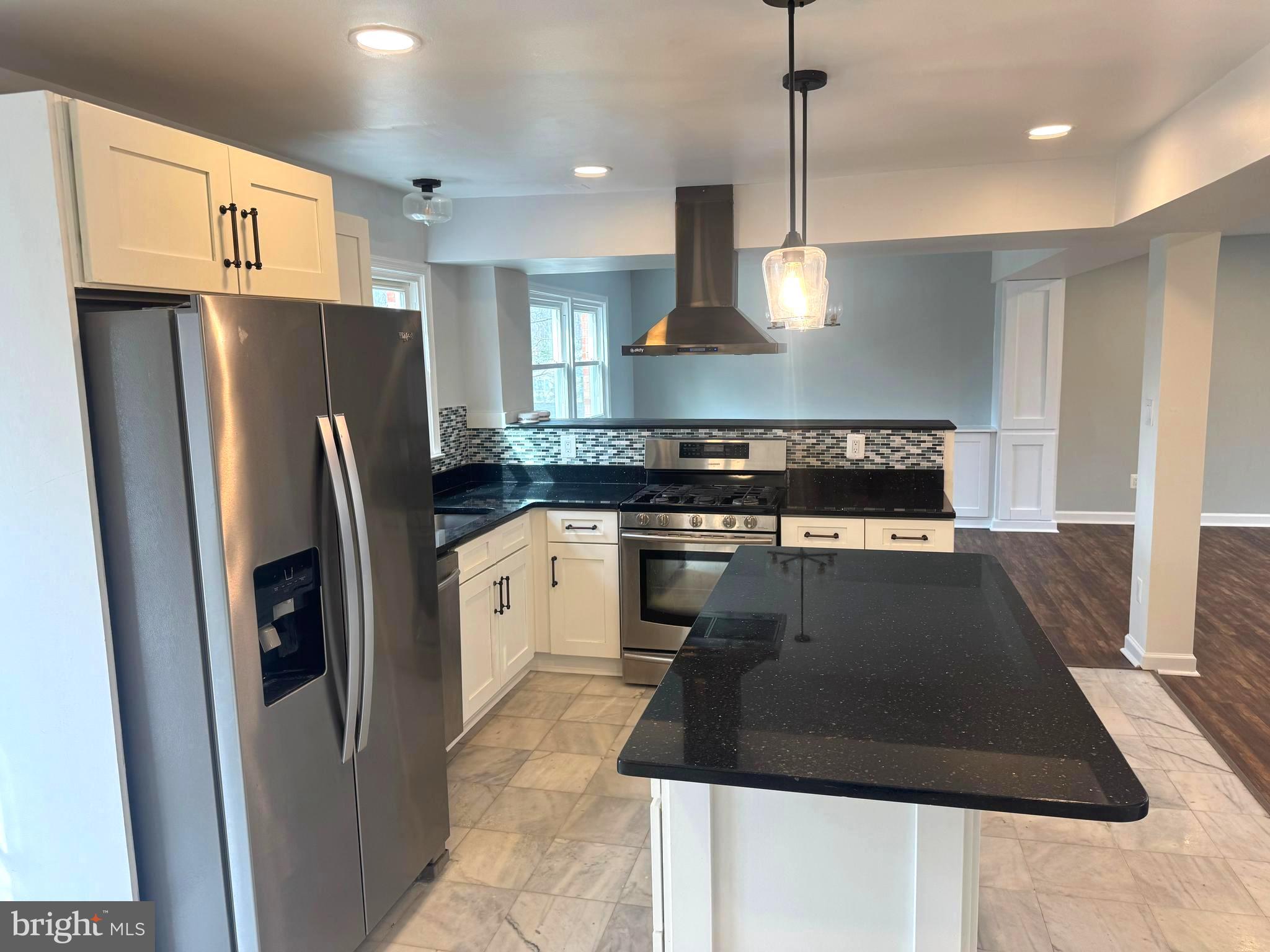 6602 Greenview Lane Springfield, VA 22152 - Photo 9 of 31 a kitchen with stainless steel appliances granite countertop a refrigerator a sink a stove and a refrigerator