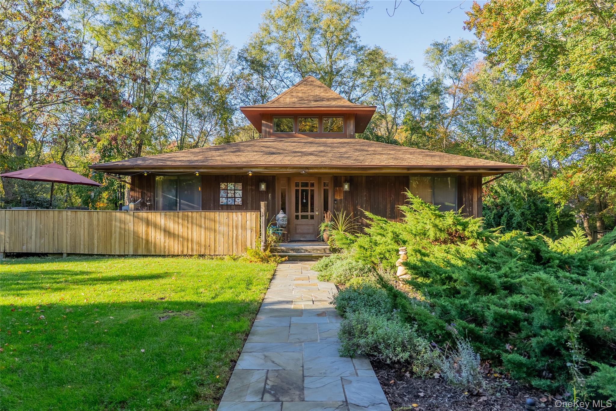 a front view of a house with garden