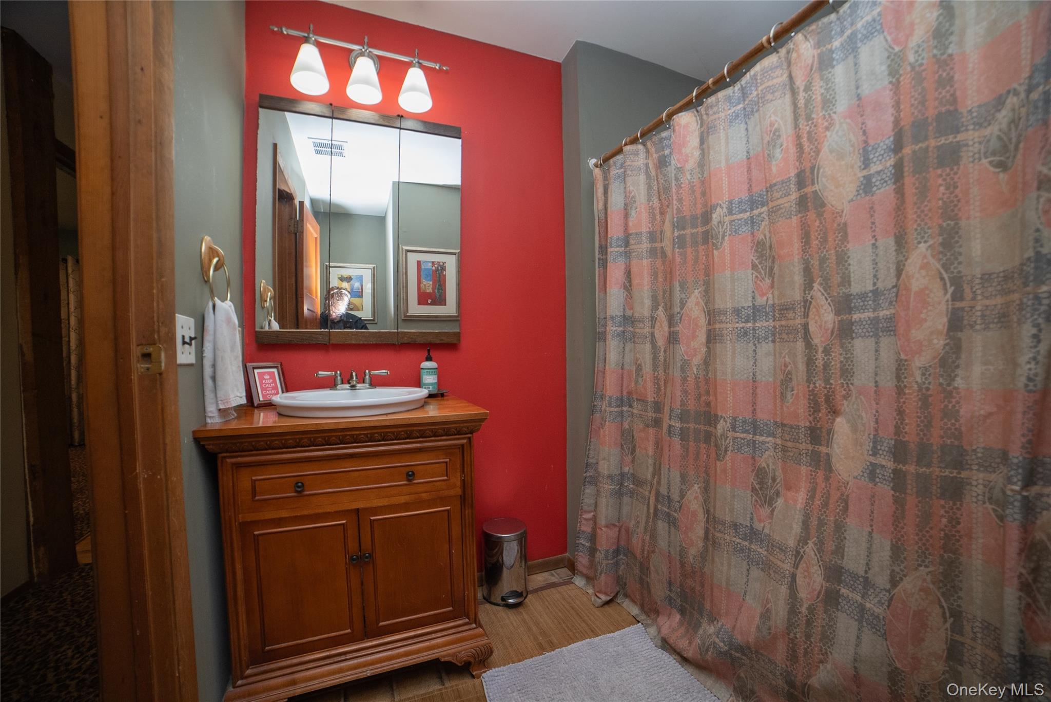 30 Long Bow Road Wading River, NY 11792 - Photo 11 of 19 a bathroom with a sink a mirror and a shower curtain