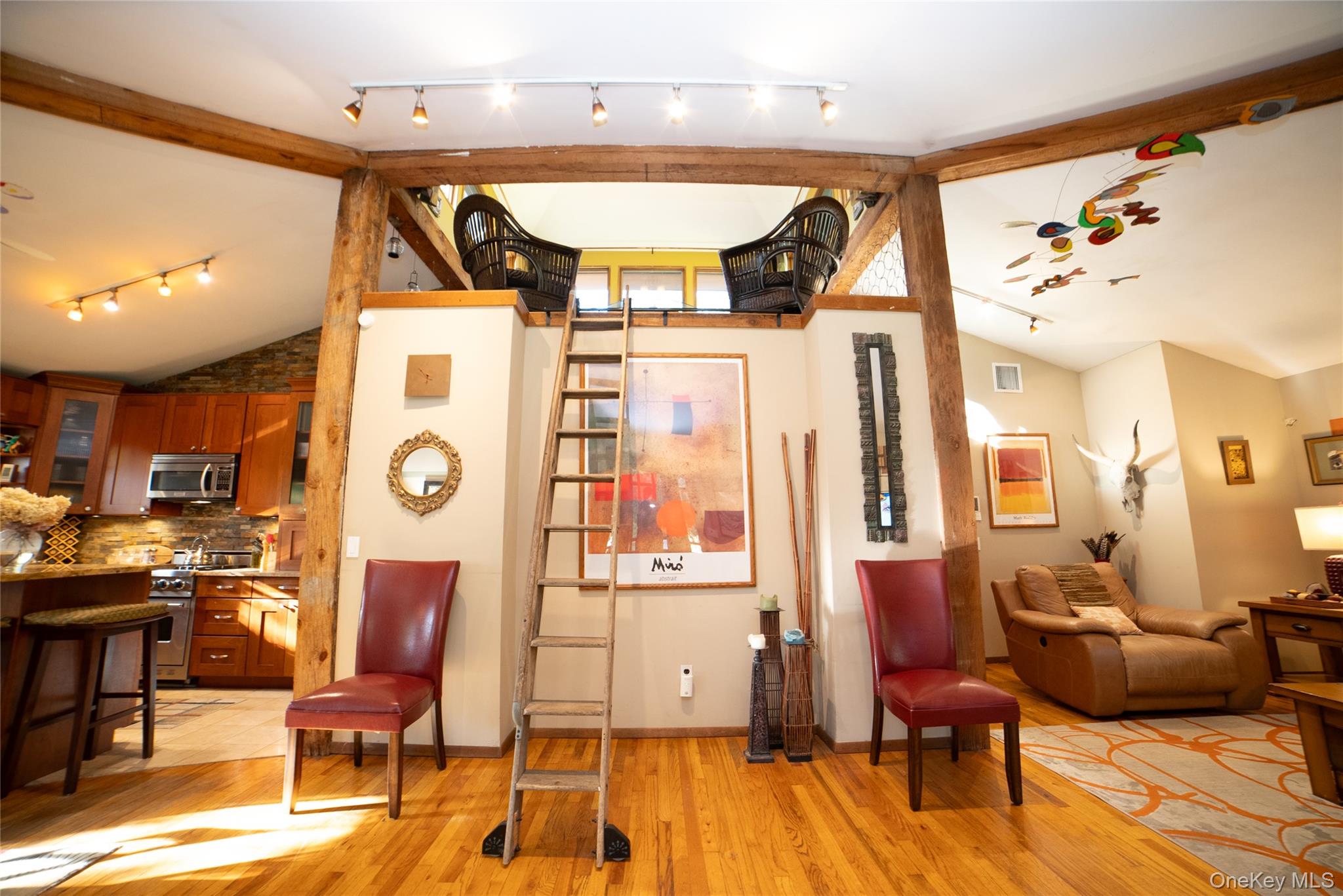 30 Long Bow Road Wading River, NY 11792 - Photo 4 of 19 a view of a room with gym equipment and wooden floor