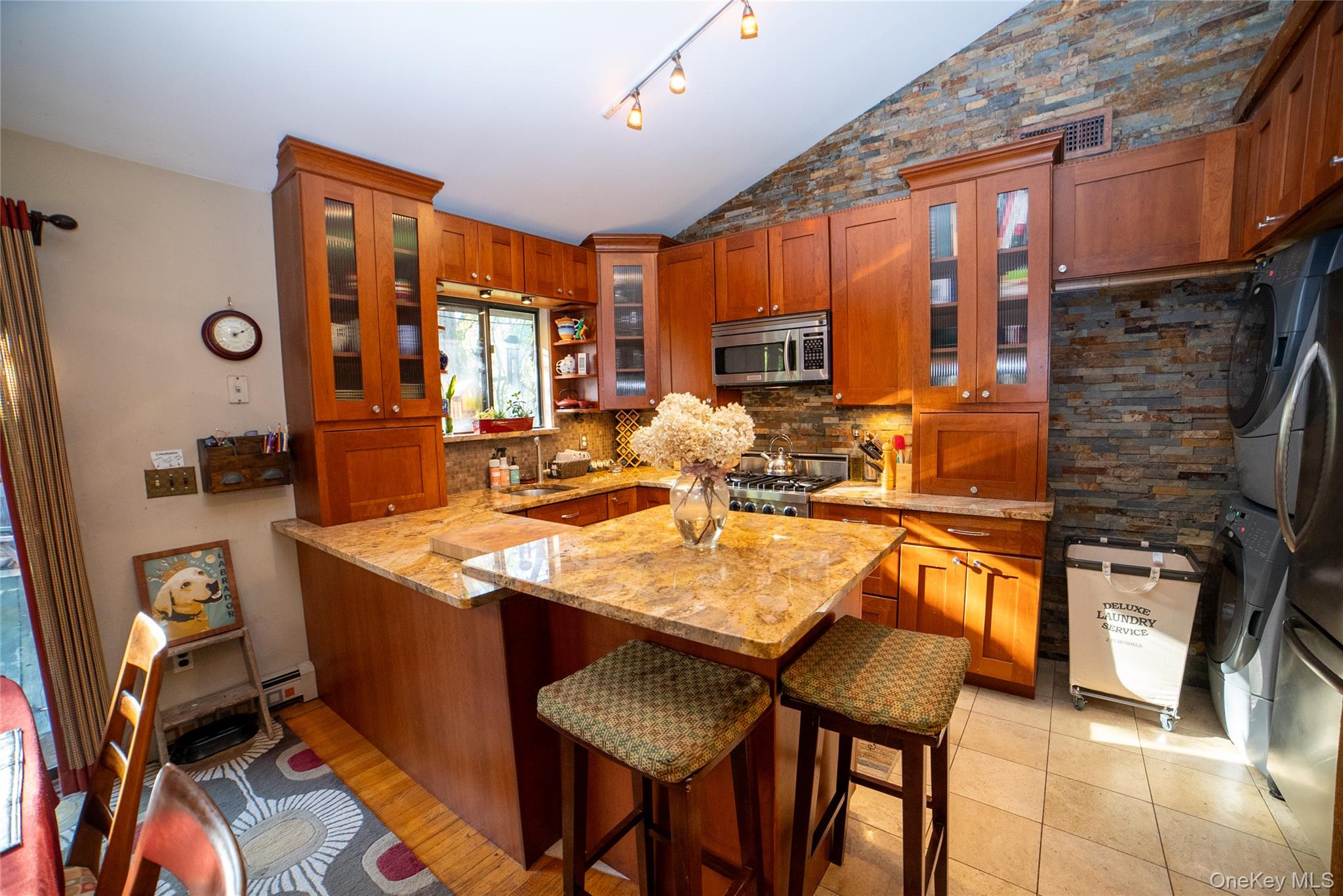 30 Long Bow Road Wading River, NY 11792 - Photo 5 of 19 a dining hall with stainless steel appliances granite countertop a stove and a refrigerator