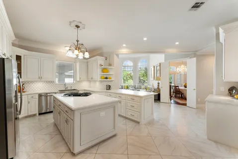 a kitchen with a stove top oven and cabinets