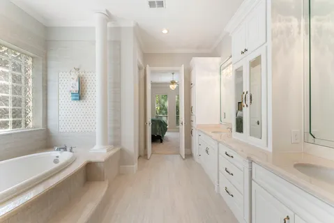 a bathroom with a granite countertop tub shower and sink