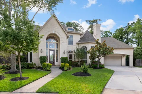 a front view of a house with a garden and plants