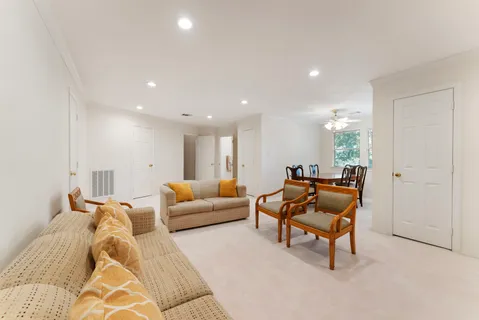 a living room with furniture and a piano