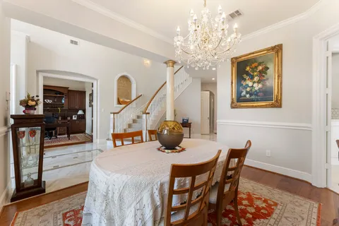 a view of a dining room with furniture and chandelier