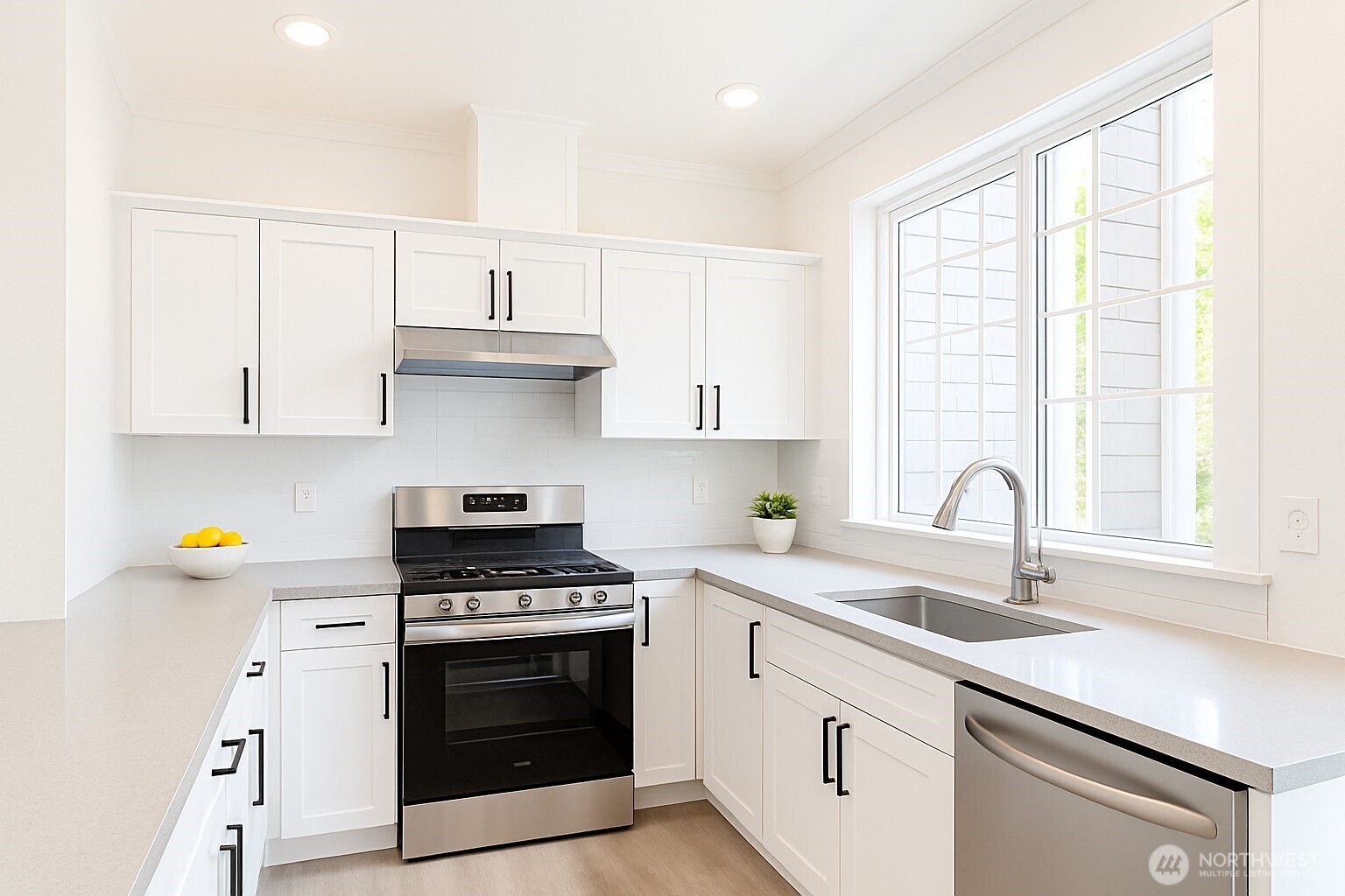 25025 Southeast Klahanie Boulevard, Unit D202 Issaquah, WA 98029 - Photo 1 of 23 a kitchen with granite countertop a sink cabinets stainless steel appliances and a window
