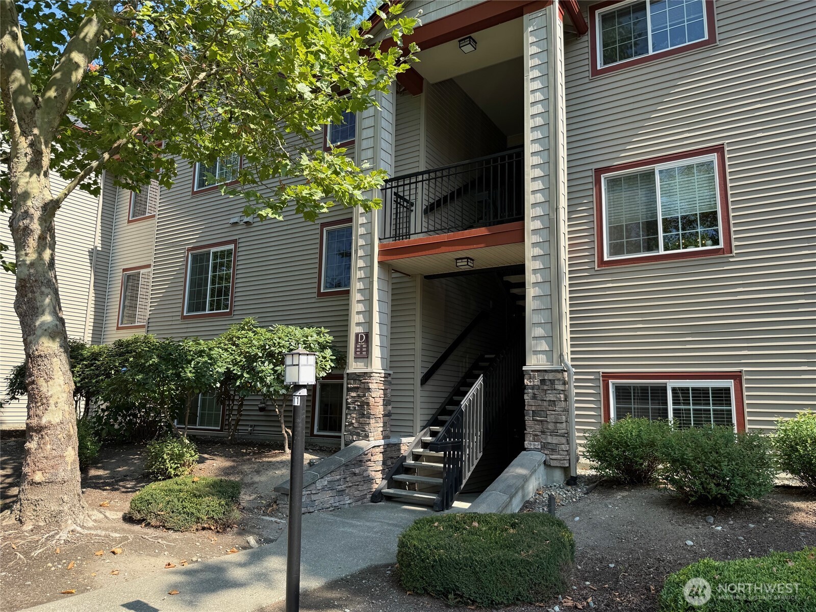 25025 Southeast Klahanie Boulevard, Unit D202 Issaquah, WA 98029 - Photo 11 of 23 a front view of a house with plants