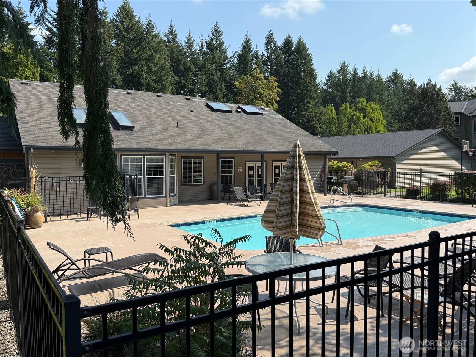 25025 Southeast Klahanie Boulevard, Unit D202 Issaquah, WA 98029 - Photo 15 of 23 a view of a house with pool and sitting area