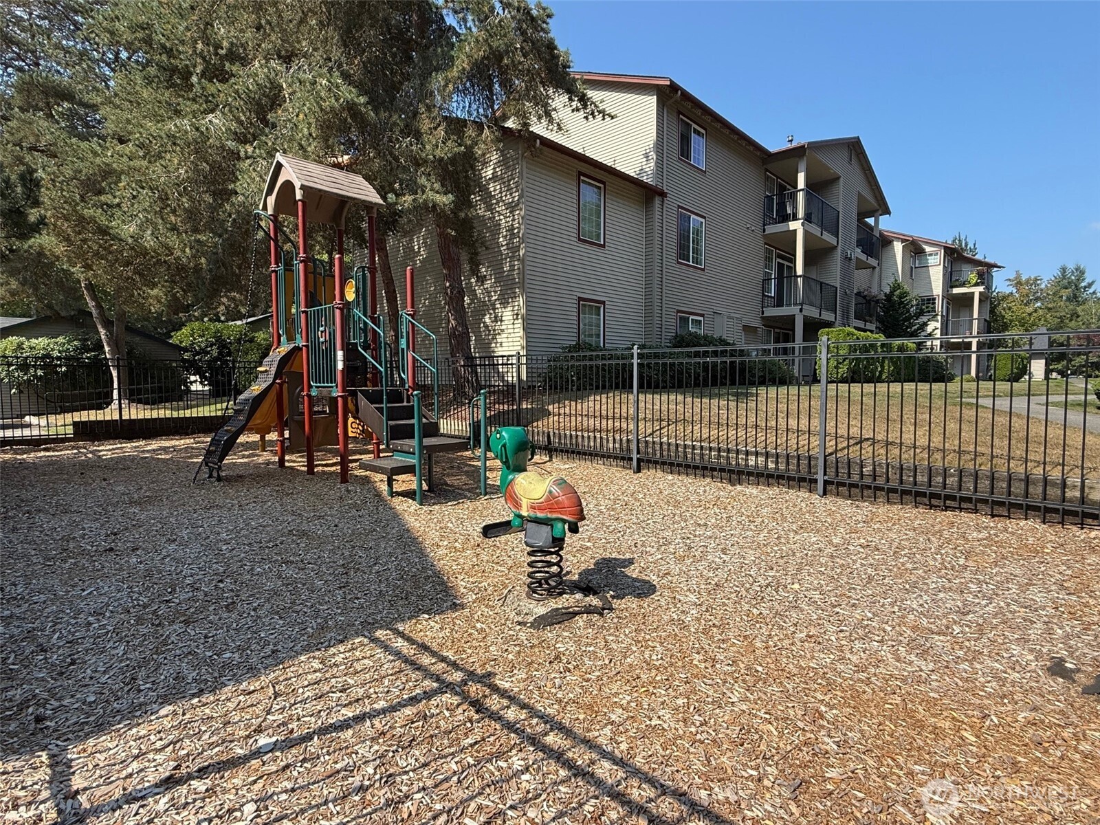 25025 Southeast Klahanie Boulevard, Unit D202 Issaquah, WA 98029 - Photo 17 of 23 a view of a park with swings and slides