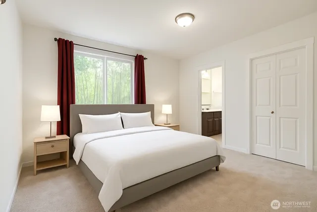 a bedroom with a bed and a night stand