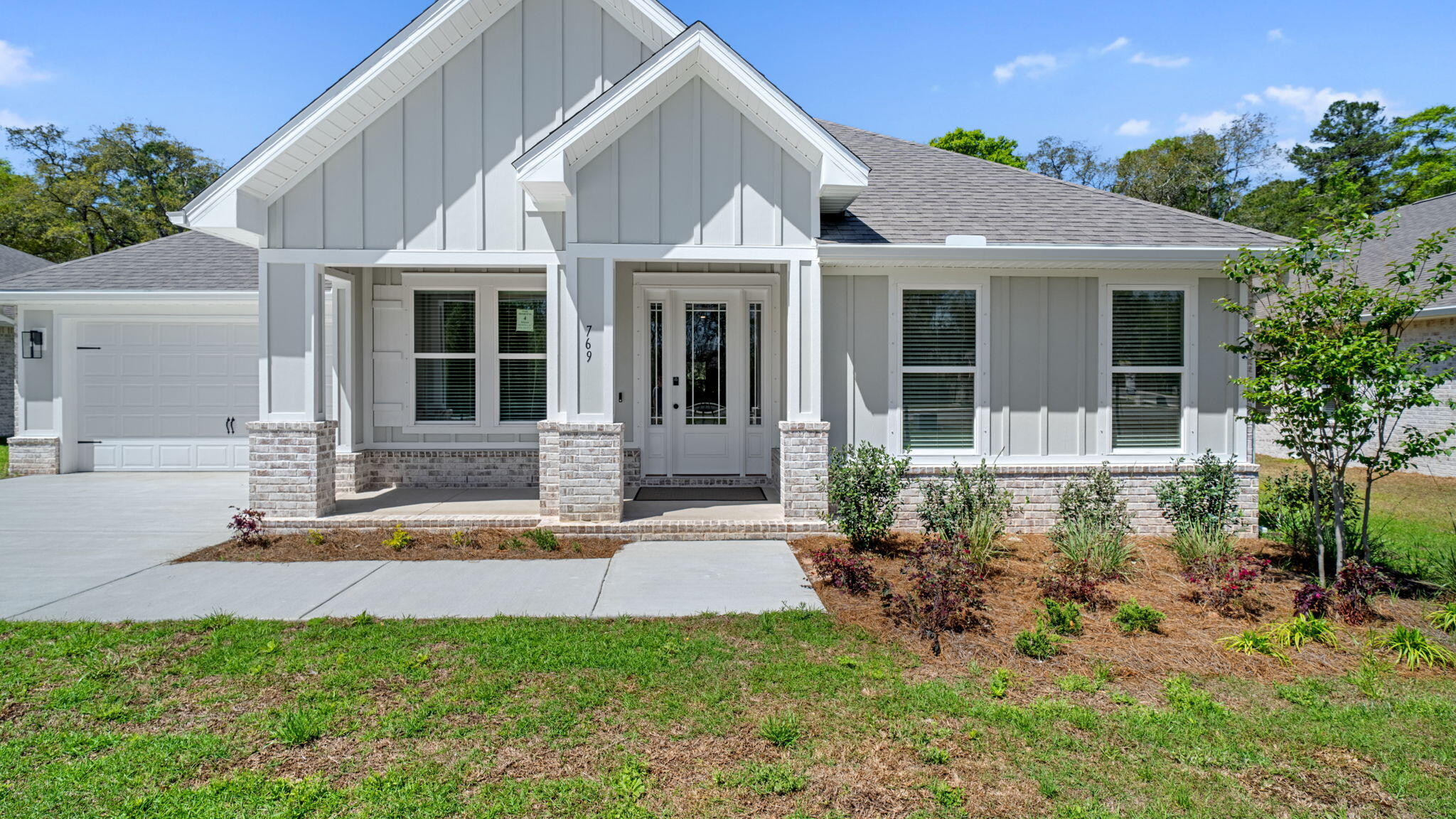a front view of a house with a garden