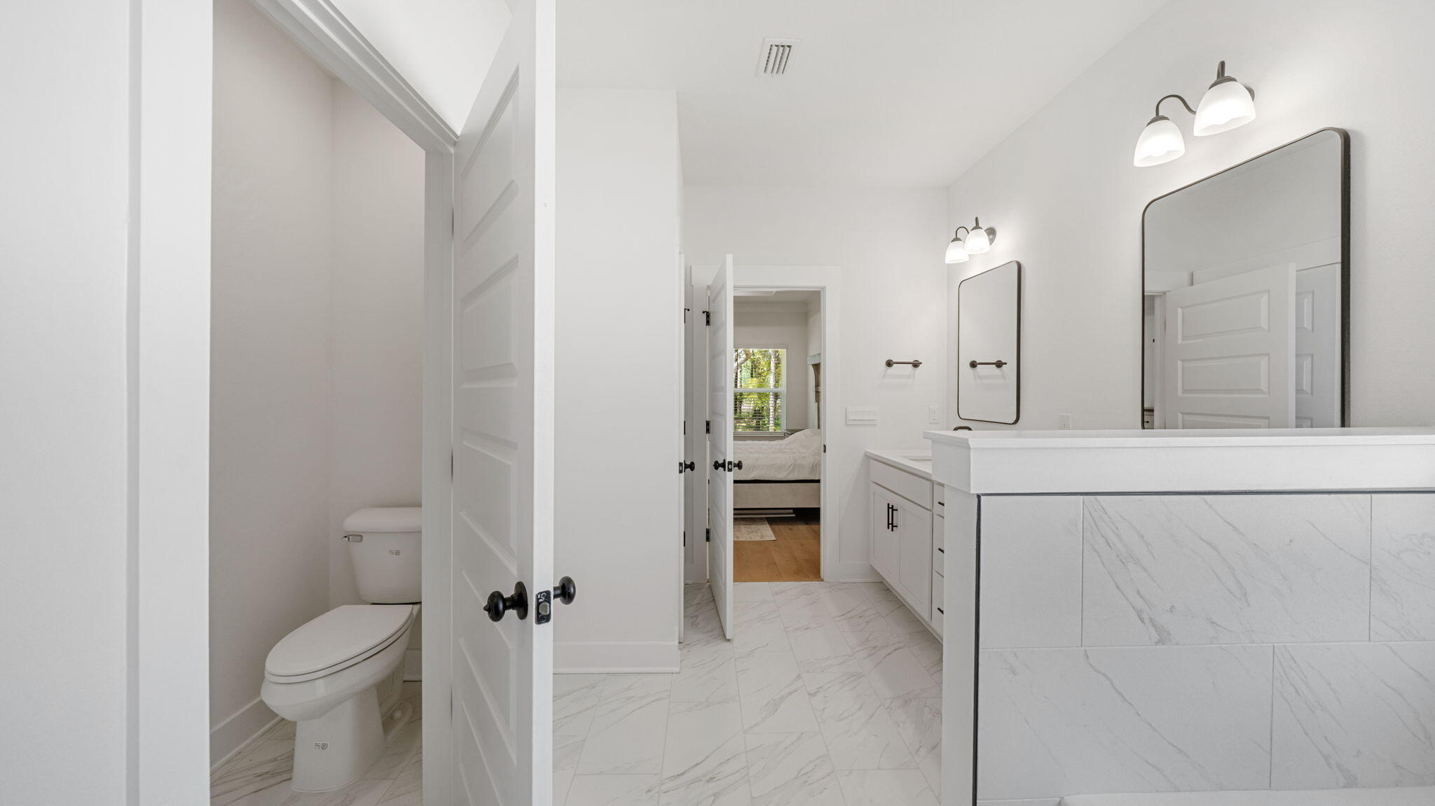 769 Old Ferry Road Santa Rosa Beach, FL 32459 - Photo 31 of 67 a spacious bathroom with a granite countertop sink mirror and toilet