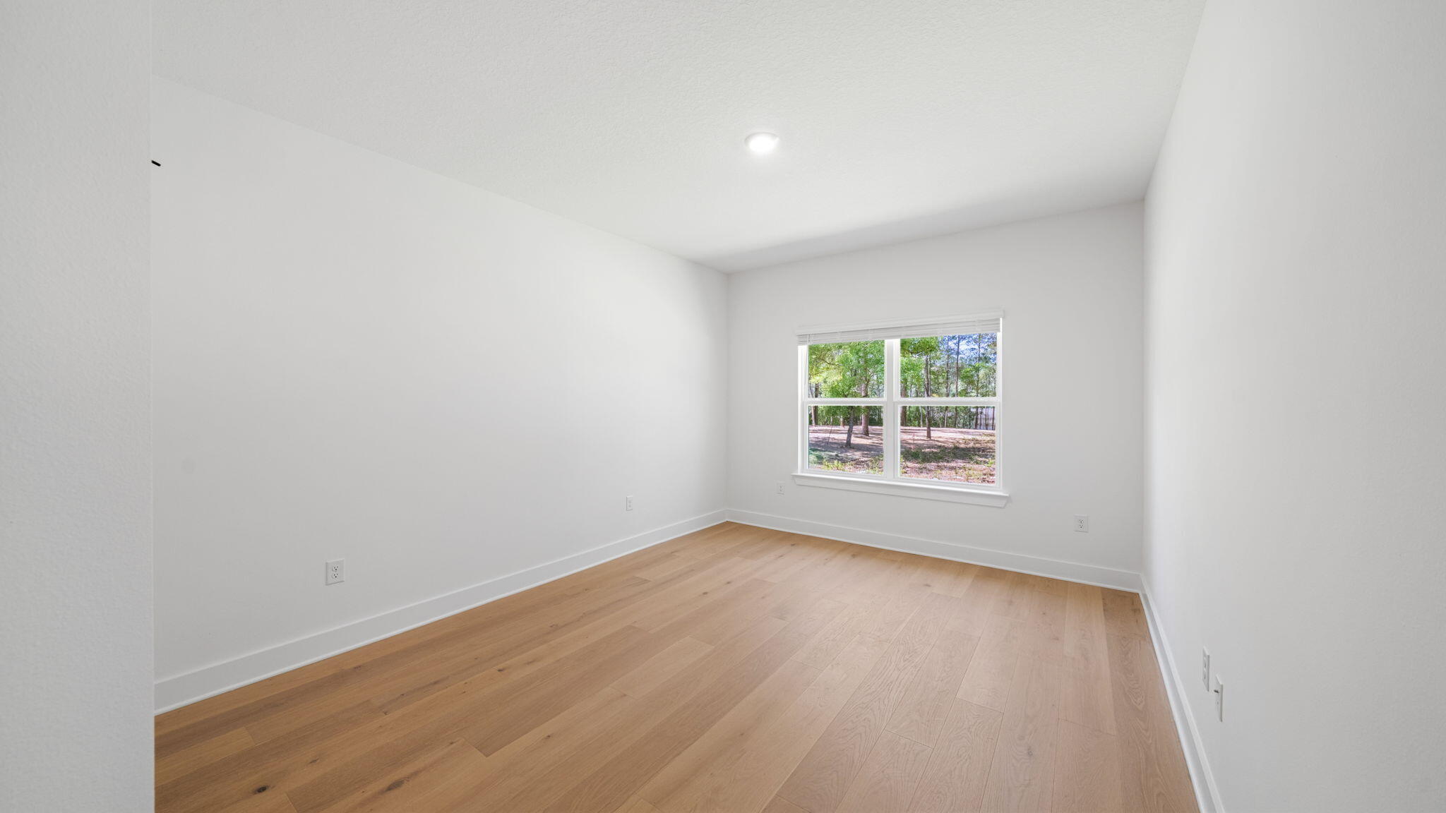769 Old Ferry Road Santa Rosa Beach, FL 32459 - Photo 37 of 67 a view of an empty room with wooden floor and a window