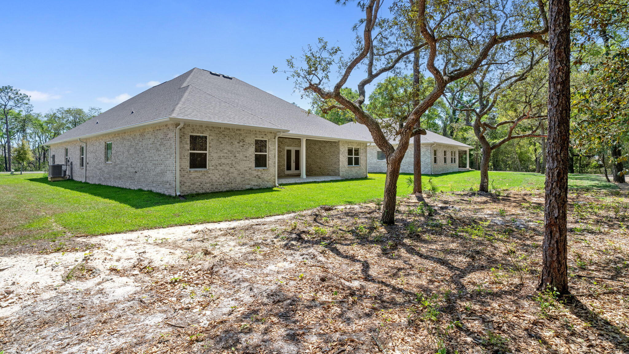 769 Old Ferry Road Santa Rosa Beach, FL 32459 - Photo 48 of 67 a front view of a house with a yard and garage