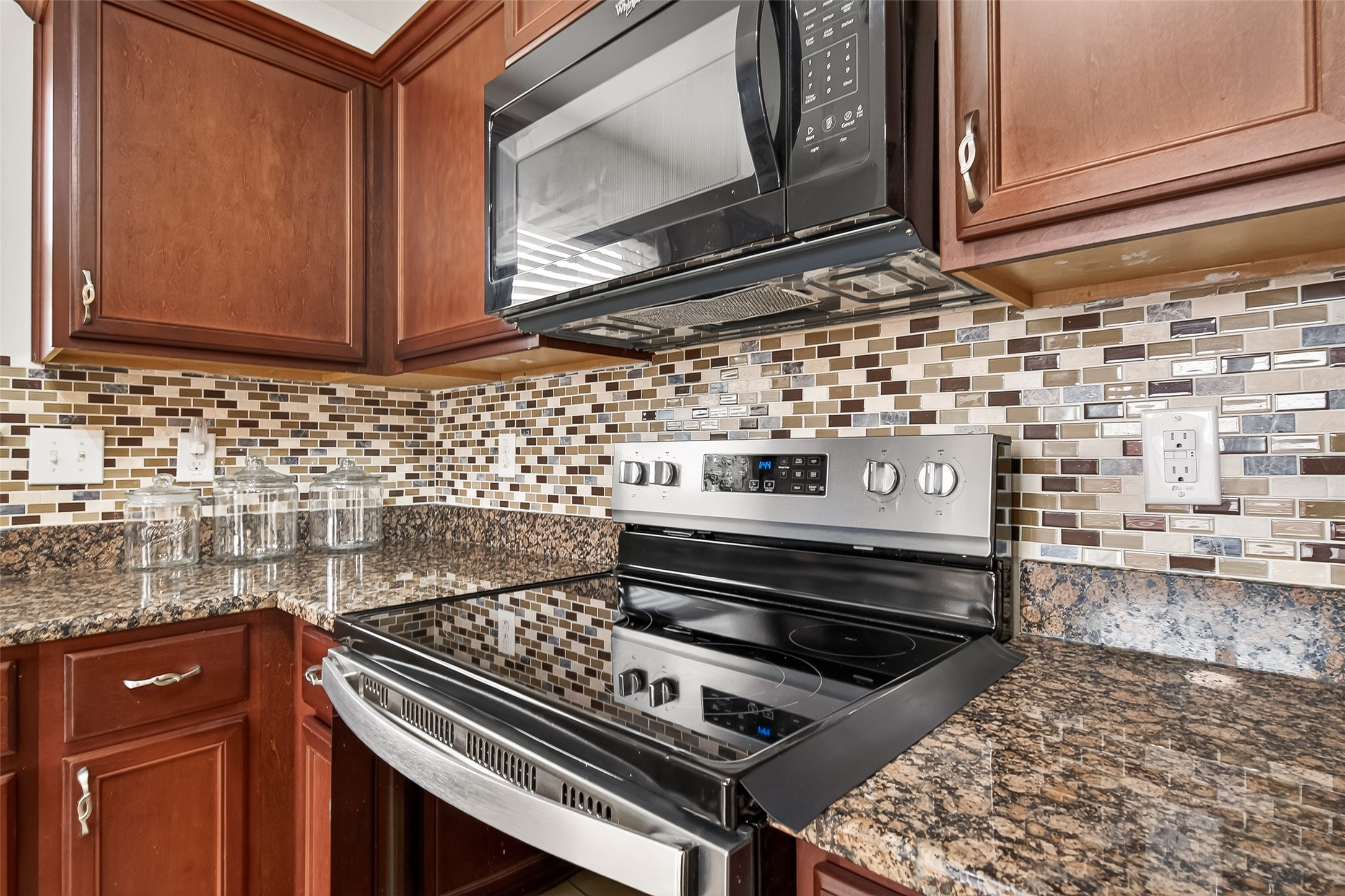 2314 Seabourne Trails Road Rosenberg, TX 77469 - Photo 11 of 38 Range stove, oven, & microwave with vent hood.