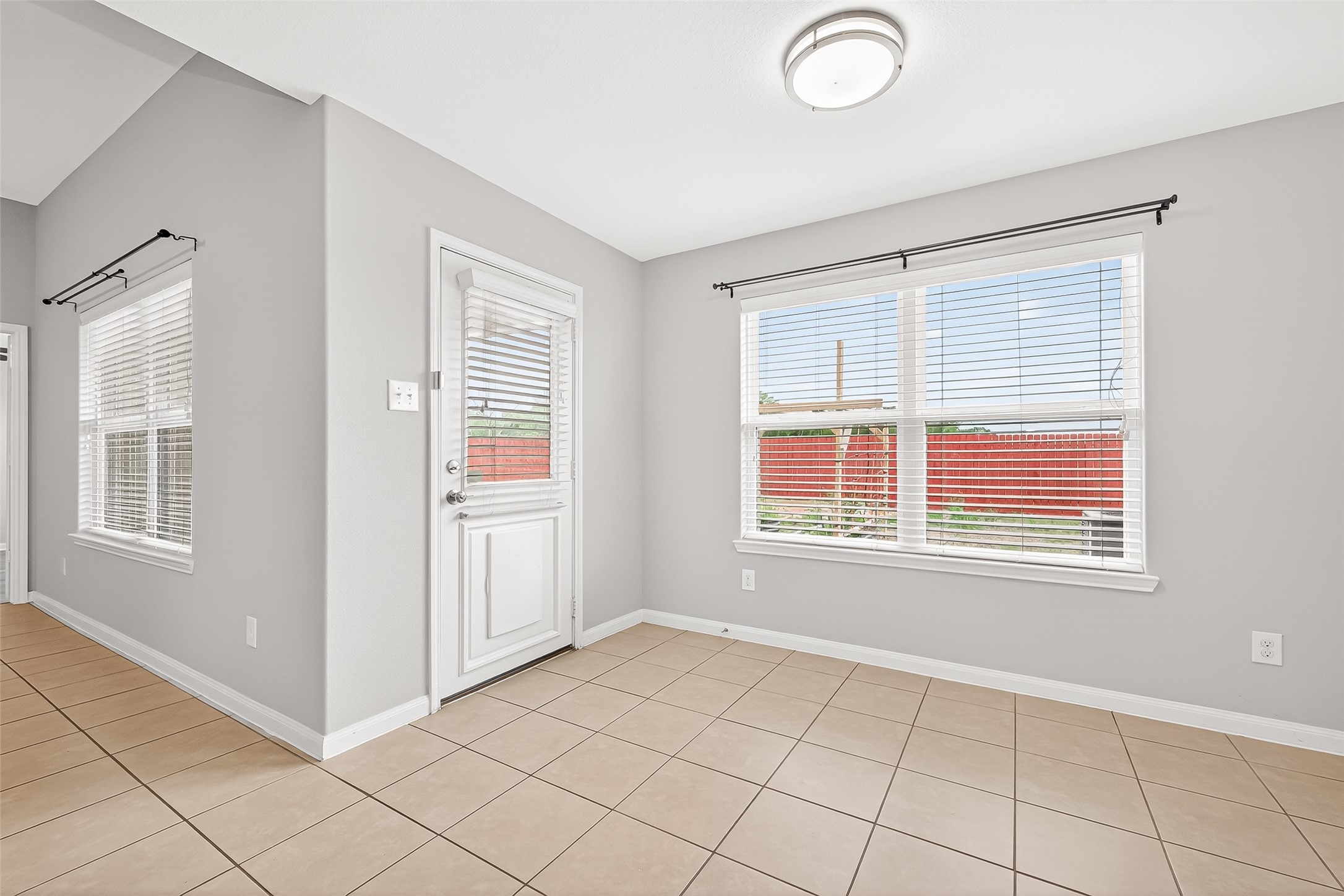 2314 Seabourne Trails Road Rosenberg, TX 77469 - Photo 17 of 38 Interior back of the house with many windows, all with functional blinds, & backdoor.