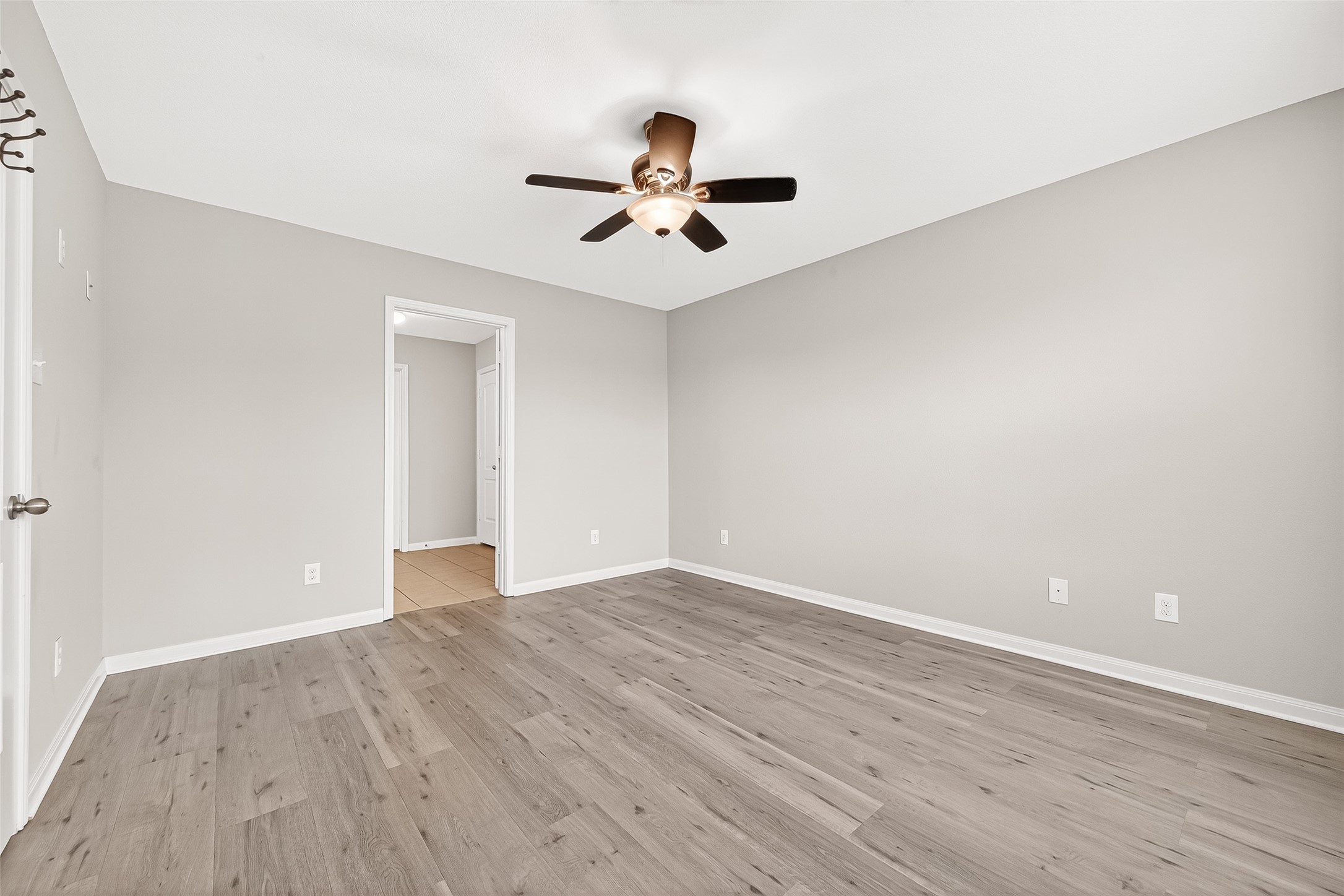 2314 Seabourne Trails Road Rosenberg, TX 77469 - Photo 25 of 38 Primary Bedroom, ceiling fan, door to the bathroom. No carpet, WP laminate flooring.