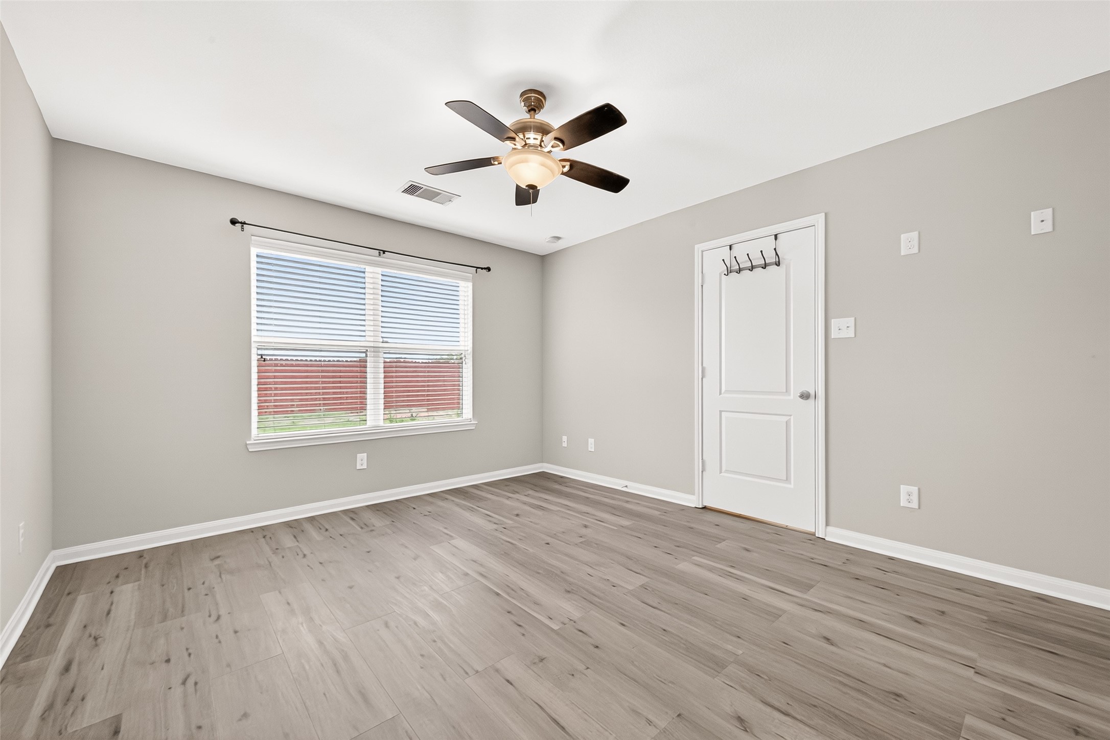 2314 Seabourne Trails Road Rosenberg, TX 77469 - Photo 27 of 38 Primary Bedroom with window facing backyard. Plenty of natural light. No carpet, laminate flooring. Fan/light combo.