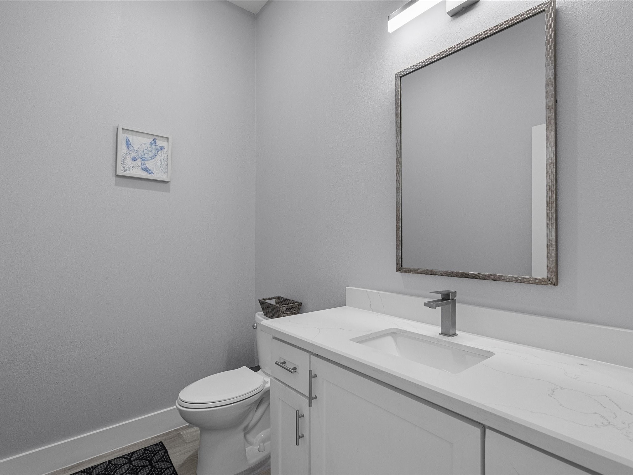 718 Beach Drive Surfside Beach, TX 77541 - Photo 28 of 49 Bright and modern room featuring colorful bunk beds, light wood flooring, and direct access to a bathroom for convenience.