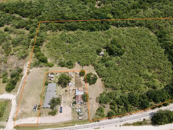 an aerial view of a house with a yard