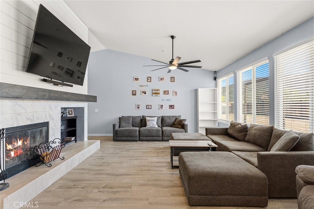 17229 Prairie Mile Road Ramona, CA 92065 - Photo 4 of 32 a living room with furniture a flat screen tv and a fireplace