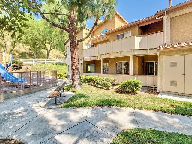 a view of a house with backyard and sitting area