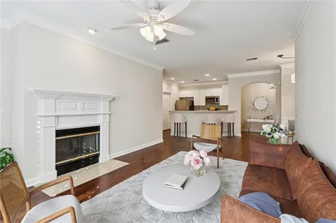 a living room with furniture a fireplace and a table