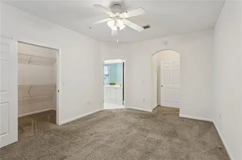an empty room with fan and entrance