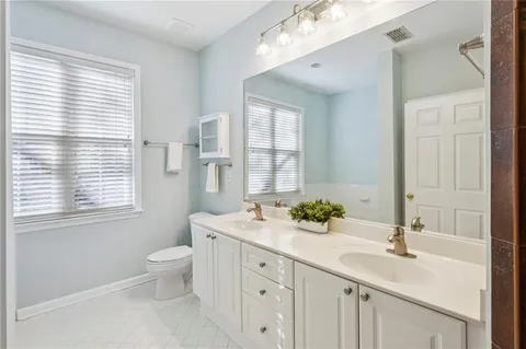 a bathroom with a sink double vanity and a bathtub