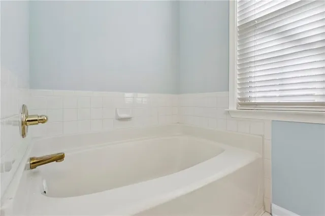 a bath tub sitting next to a window