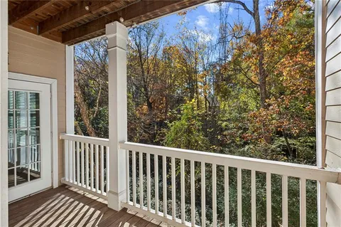 a view of a patio with table and chairs and potted plants