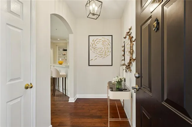 a view of a hallway with wooden floor and entryway