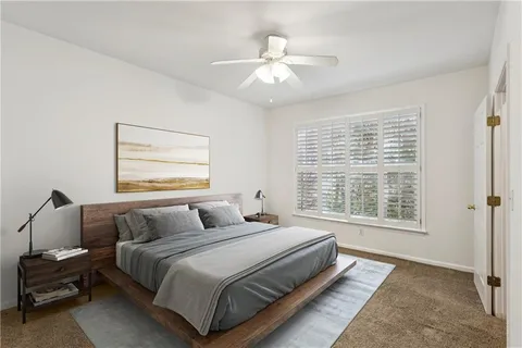 a bedroom with a large bed and a window