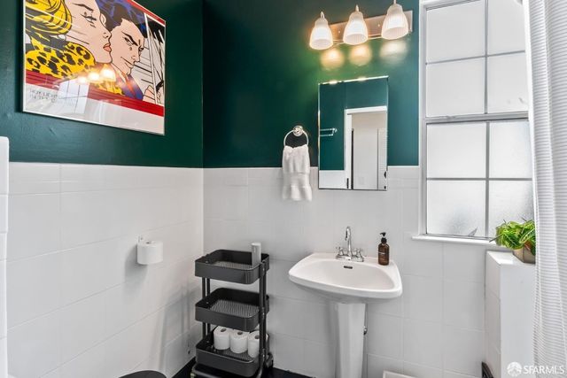 a bathroom with a sink a mirror and a toilet