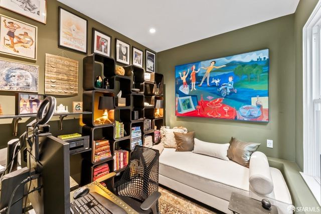 a living room with furniture and wall paintings