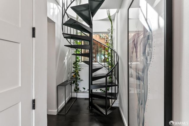 a view of entryway with wooden floor and stairs
