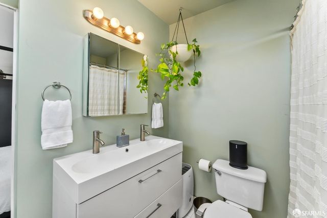 a bathroom with a toilet sink and mirror