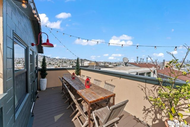 a terrace with a table and chairs