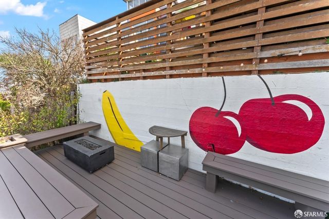 a view of a balcony with wooden benches and city view