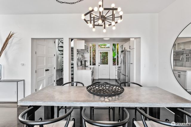 a kitchen with a table chairs and stove