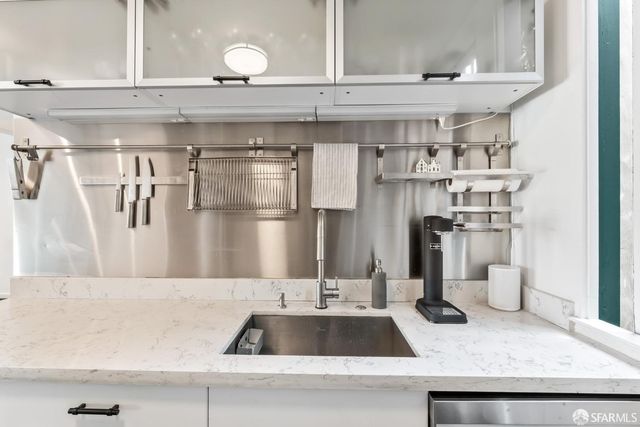 a kitchen with a sink and refrigerator