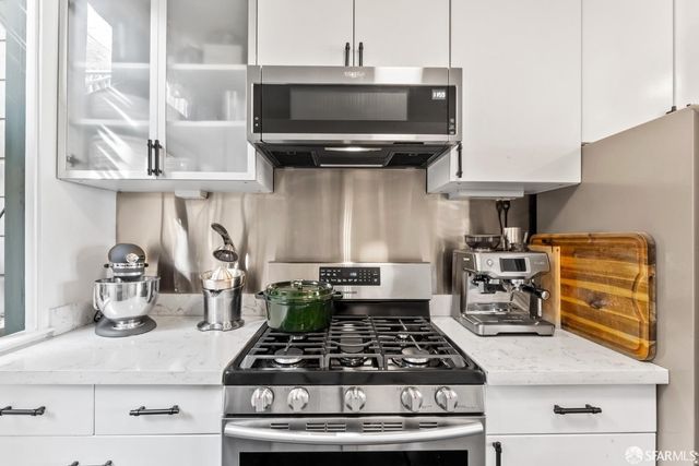 a kitchen with a stove and cabinets